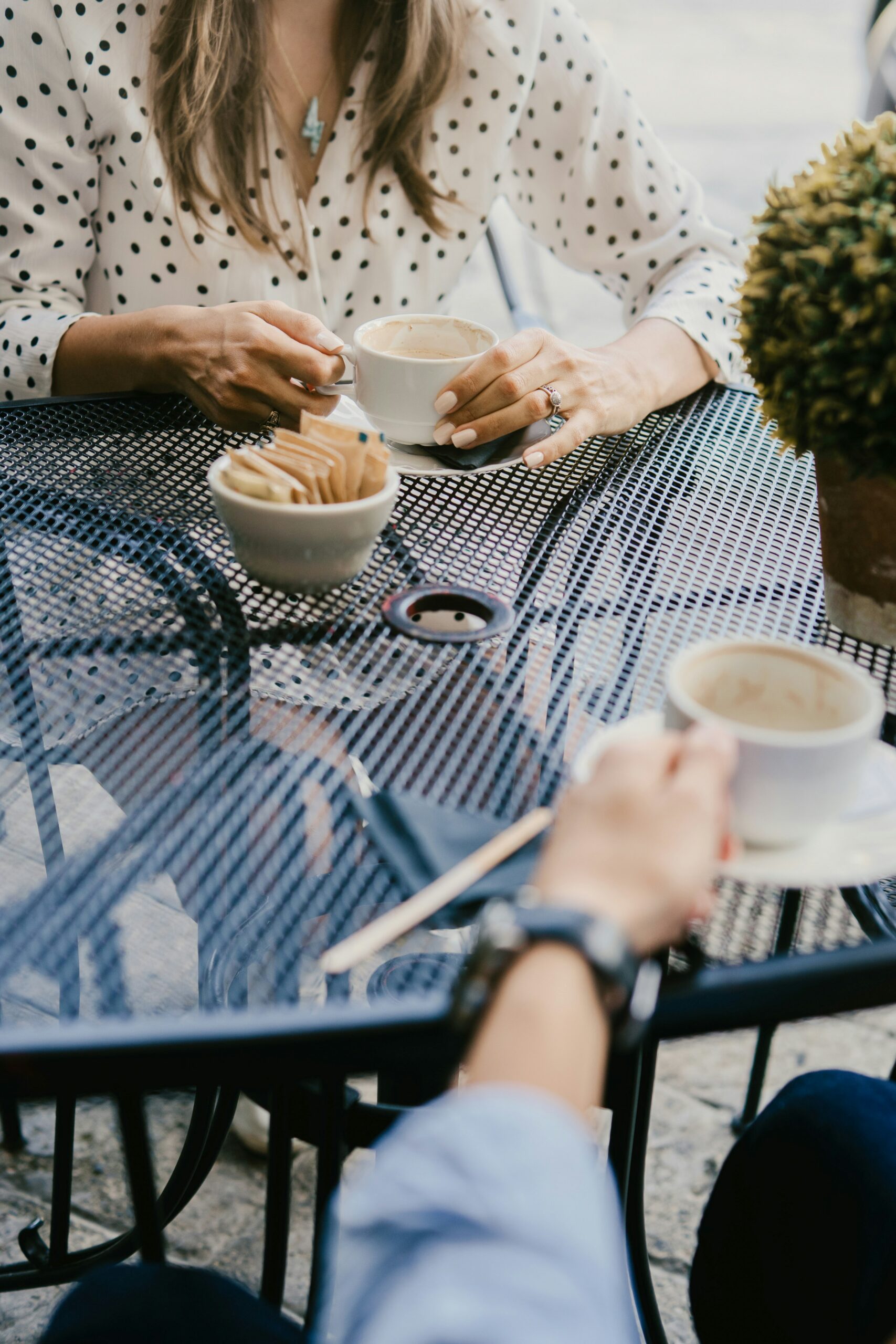 Two people sharing coffee at a café table