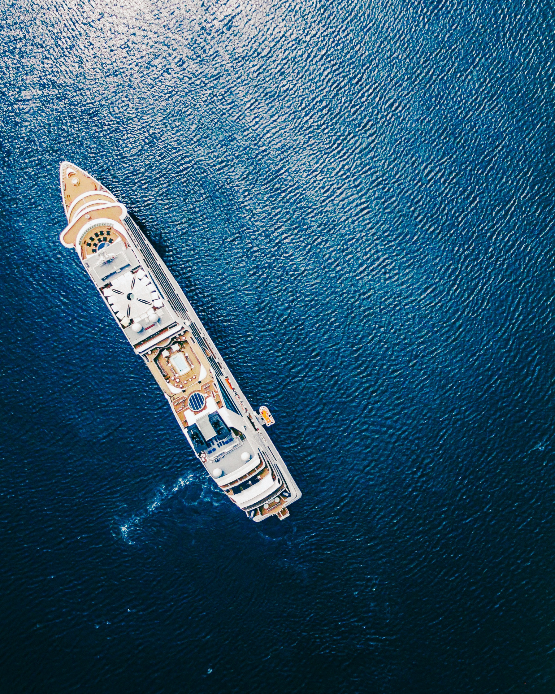 A luxury ship anchored off a coastal village.
